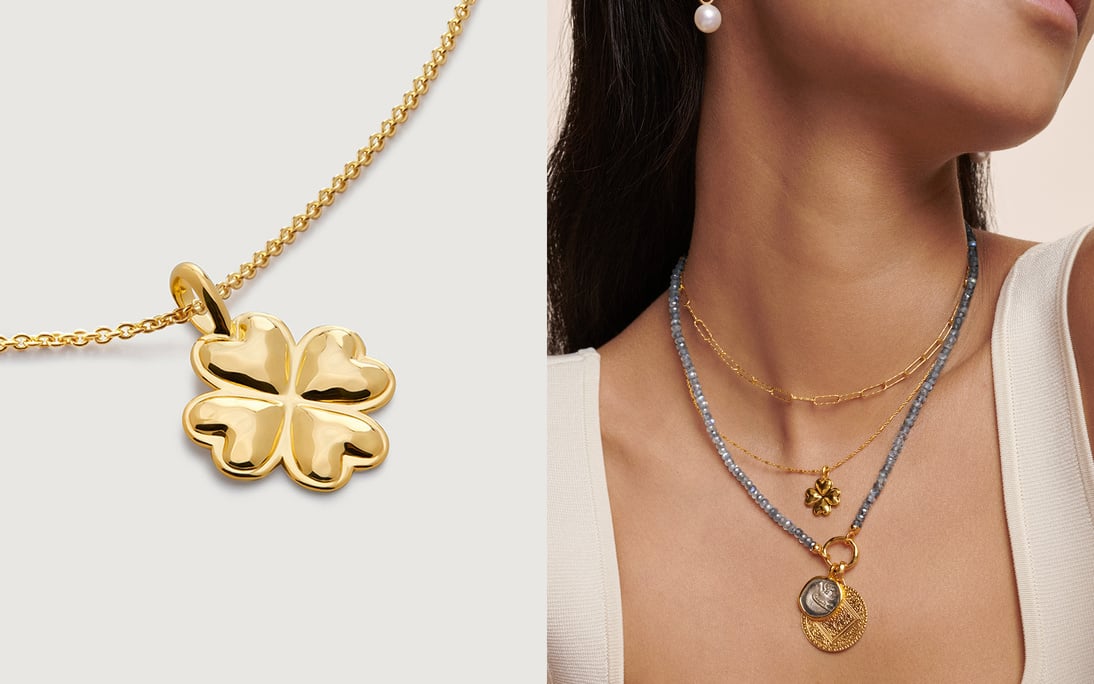 A model wearing layered necklaces with talisman pendants